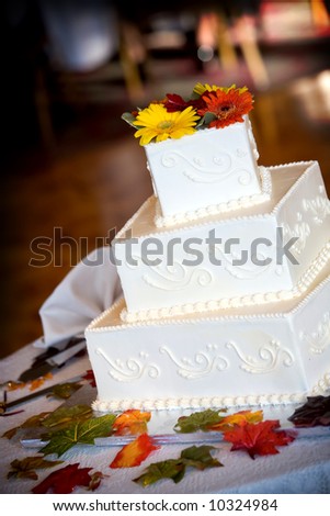 this wedding cake is covered in small details and decorated with leaves