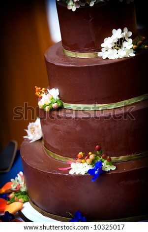 a chocolate wedding cake ready to be cut