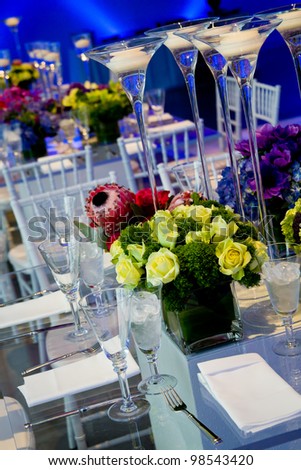 wonderful wedding decorations, with clear glass tables, flowers, and candles