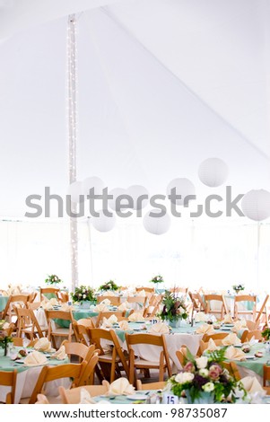 A look inside a tent set for fine dining during a wedding or other catered event