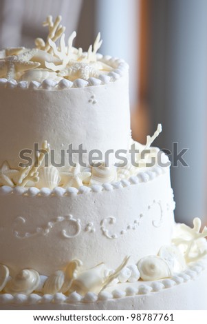stock photo white ocean themed wedding cake with miniature seashell design