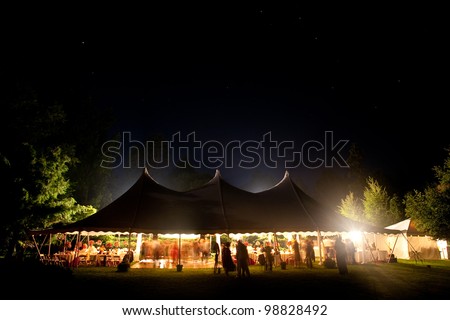 Beautiful wedding tent set up for an outdoor reception. This is a long night exposure, there is blur under the tent showing activity