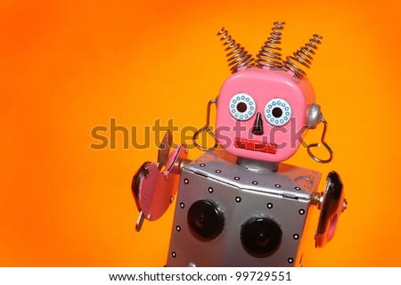 a pink and silver toy maid robot with an orange background