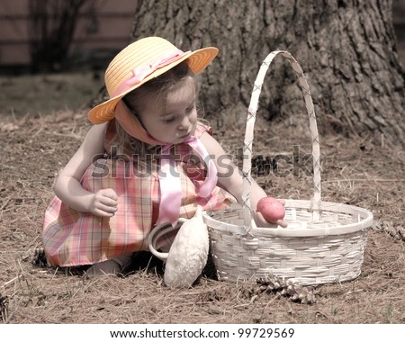 Little girl dressed in her sunday best on easter with a basket and an egg, this image was made to have an old feel to it. The clothes and egg are done in muted colors, the rest is in a light sepia
