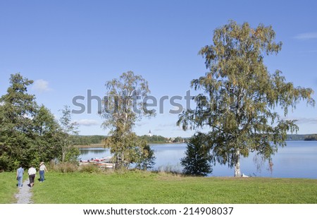 NORA, SWEDEN ON SEPTEMBER 10. View of the lake and bridge this side the town on September 10, 2011 in Nora, Sweden. Unidentified people by the lake.