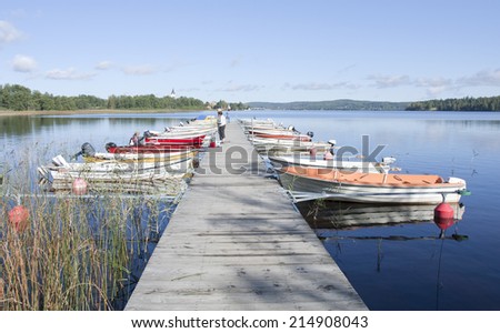 NORA, SWEDEN ON SEPTEMBER 10. View of the lake and bridge this side the town on September 10, 2011 in Nora, Sweden. Unidentified people by the lake and on the bridge.