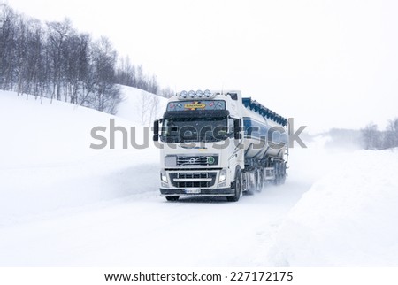 EUROPEAN ROUTE 12, SWEDEN ON MARCH 12. Truck in snowy weather on March 12, 2012 in European Route 12, Sweden. Newly fallen snow. Heavy snowdrift behind the vehicle.