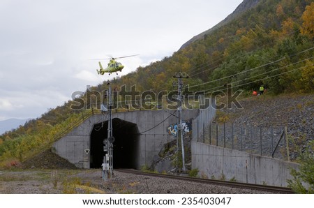 IRON ORE LINE, SWEDEN ON SEPTEMBER 11. An ambulance helicopter comes in after a accident on September 11, 2014 along the Iron Ore Line, Sweden. Lands on a railway tunnel.