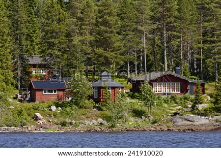 BALTIC SEA, SWEDEN ON JUNE 29. The Swedish archipelago along the shore on June 29, 2011 in The Baltic Sea, Sweden. Red lodges, cabins by the sea. Forest and rocks.