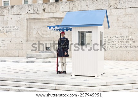 ATHENS, GREECE ON APRIL 15. Guard on duty outside the Parliament building at Syntagma on April 15, 2011 in Athens, Greece. Inscription and artwork on the wall behind.