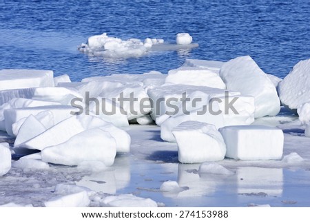 Blocks of ice and snow on the shore. The Baltic Sea in March during the day, hours when the ice at sea breaks up.