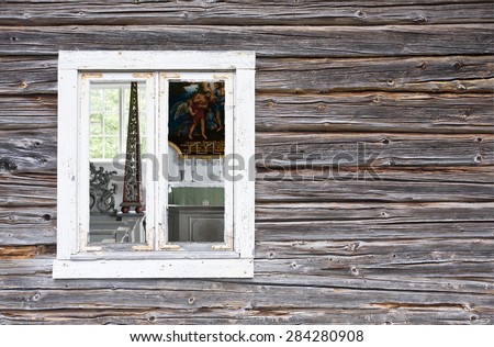 BALTIC SEA ON JULY 16. Indoor view through a window of a small wooden chapel on July 16, 2012 next to the Baltic Sea, Sweden. Log, timber wall in the foreground.