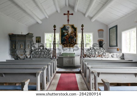 BALTIC SEA ON JULY 16. Indoor view of a small wooden chapel on July 16, 2012 next to the Baltic Sea, Sweden. Benches, pulpit and an alter in traditional carpentry from late 1700s.