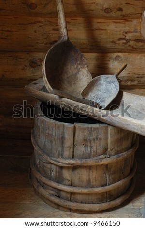 Wooden barrel, trough, scoop in old country house, north Russia