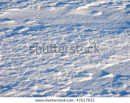 Close up of snow surface texture on sunny day
