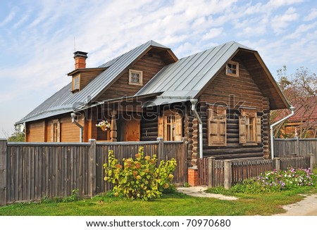 Country wooden house with closed shutter on windows, Russia