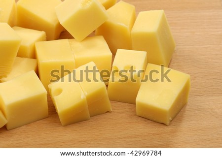 stock photo : blocks of Dutch cheese on a wooden tray