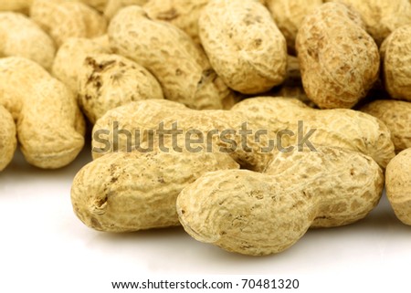 a bunch of fresh roasted peanuts on a white background