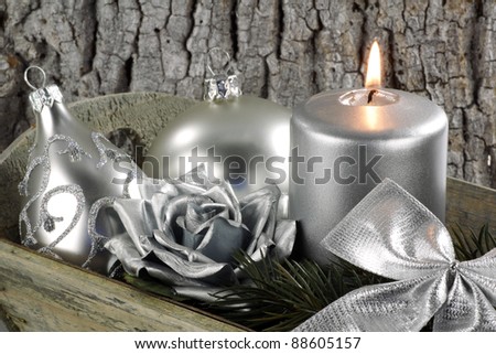 christmas scene with silver candle and some christmas baubles