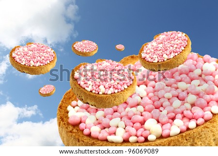flying rusks with white and pink anise seed sprinkles served in Holland when a baby girl is born
