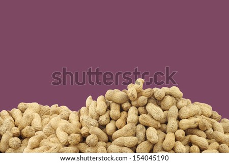 bunch of roasted peanuts on a purple background