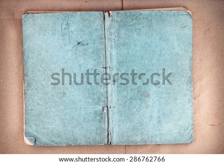 Old open book cover on brown paper background