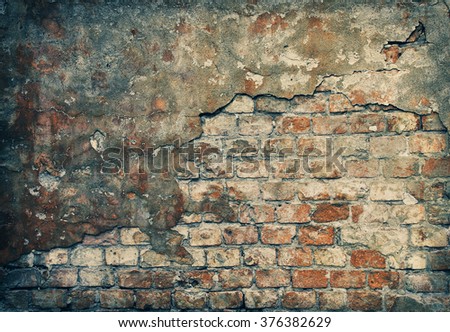 Old damaged brick wall with plaster