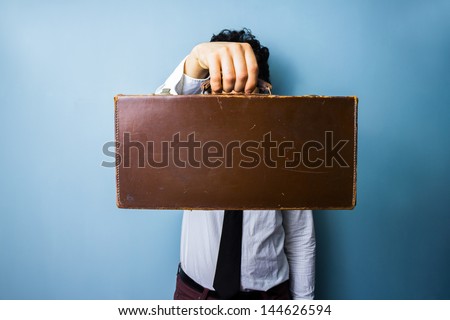 Businessman presenting a briefcase of importance