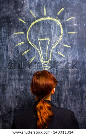 Redhead businesswoman having a bright idea