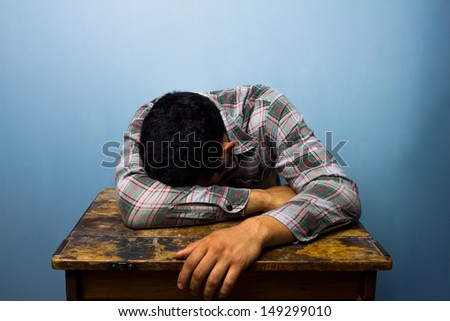 Young man sleeping at desk