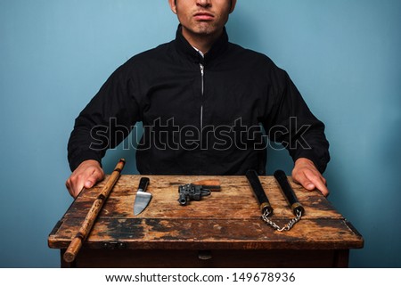 Gangster with various weapons