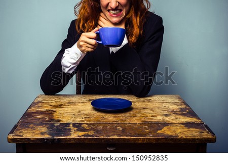 Businesswoman has had a very bad cup of coffee