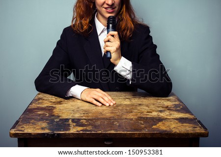 Woman in suit giving lecture