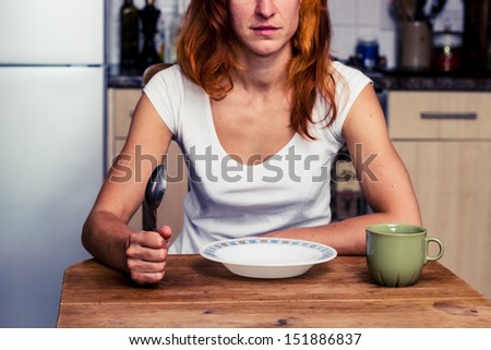 Woman about to have breakfast in kitchen