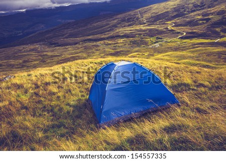 Wild camping with tent on mountain
