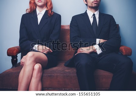Man And Woman Waiting To Enter A Job Interview