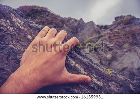 Man\'s hand on rock