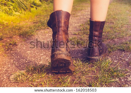 Close up on woman\'s muddy boots