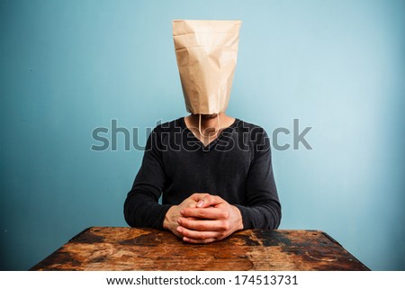 calm and relaxed man with bag over head