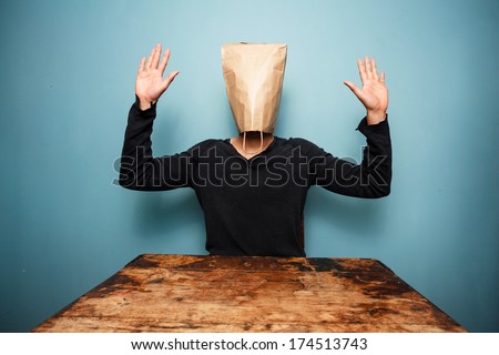 scared man with bag over head