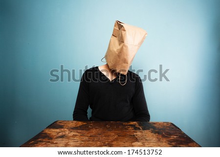 sad man with bag over head