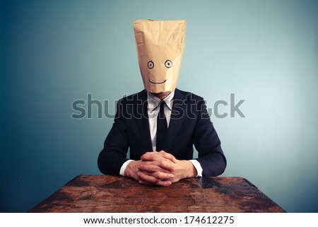 Relaxed businessman with bag over head