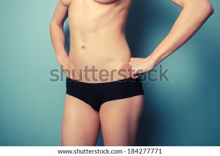 Slender young woman is wearing black underwear