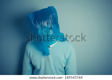 A man is wearing a plastic bag over his head