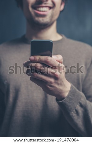 A young man is using a smart phone