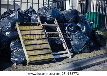 A large pile of rubbish bags on the street