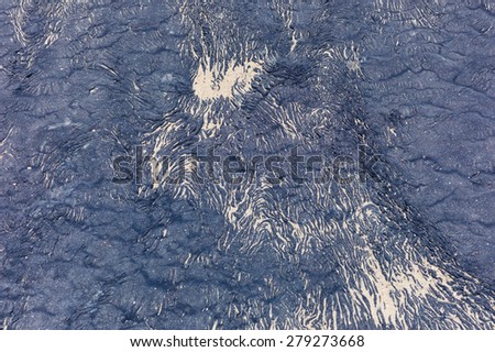 Tar texture with sand from a beach