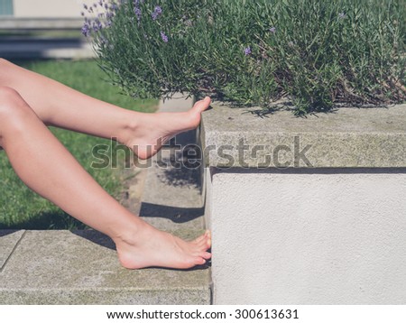 The feet of a young woman as she is relaxing outside