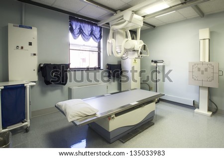 Radiography table in the middle of an x-ray room