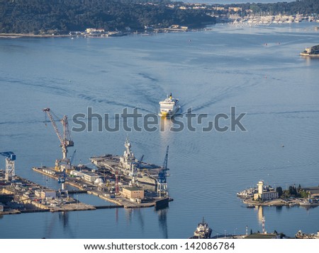 Ferry arriving from Corsica in the harbor of Toulon, right in front of the aircraft carrier Charles de Gaulles